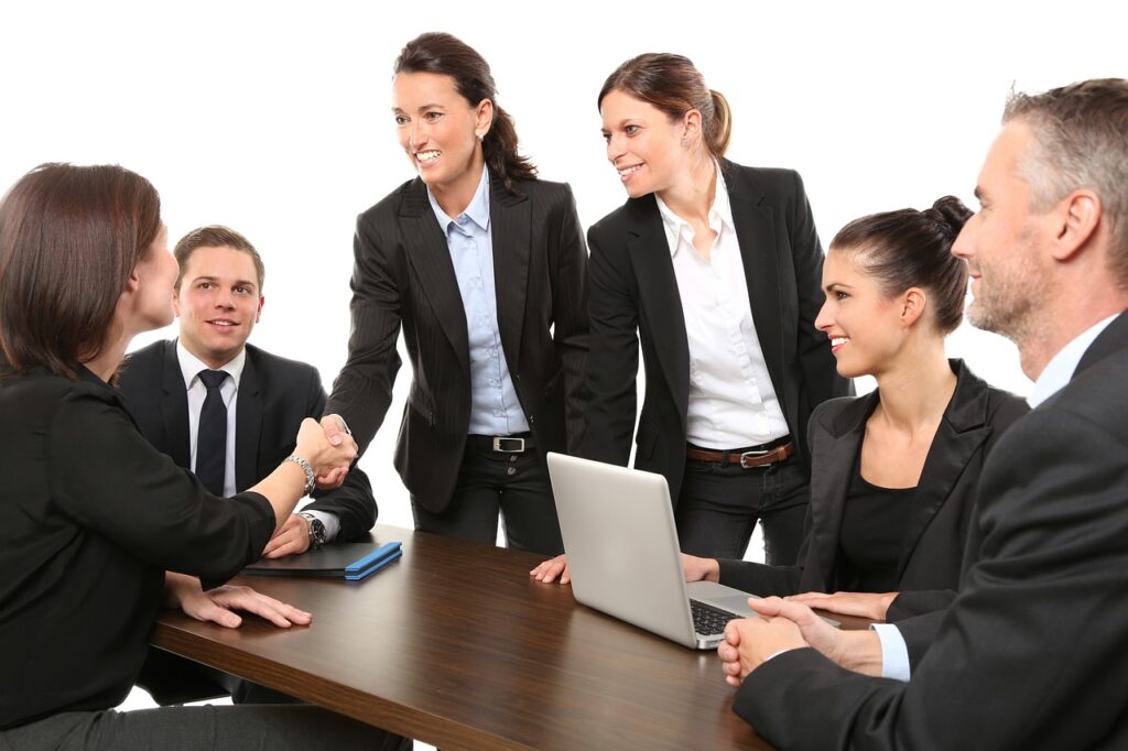 People in a business setting shaking hands